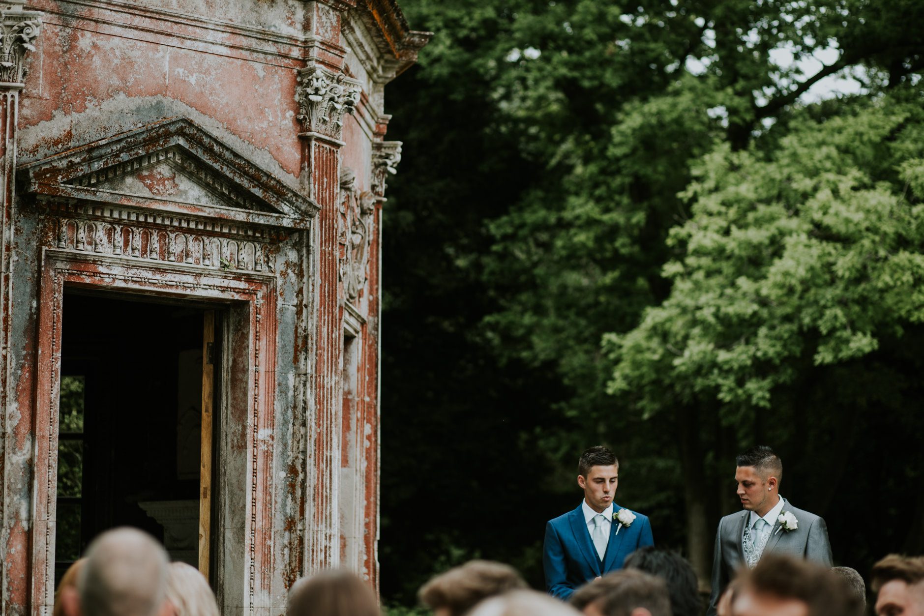 The groom and best man wait for the bride at a Larmer Tree wedding