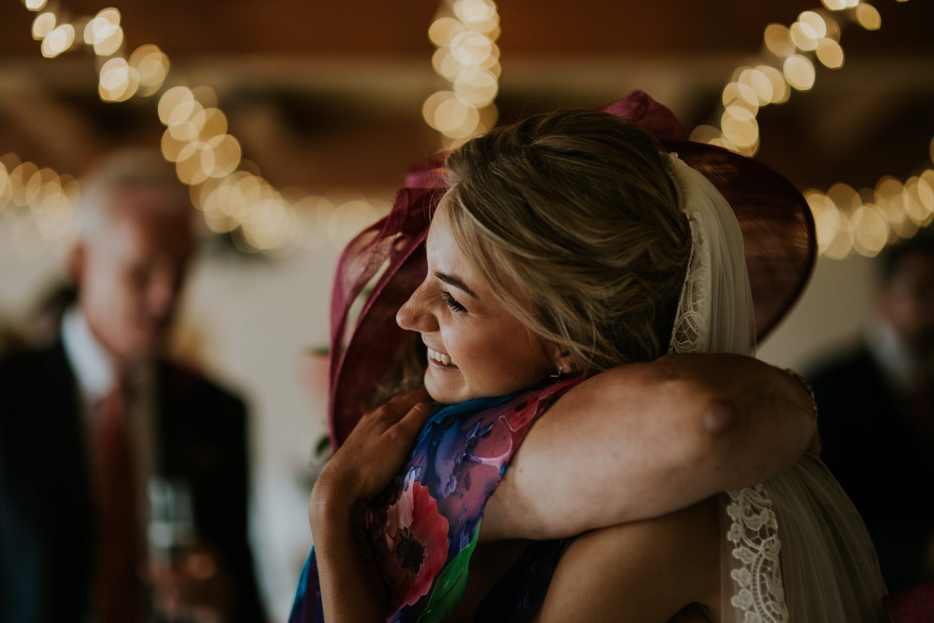 bride hugs her mother after her wedding ceremony