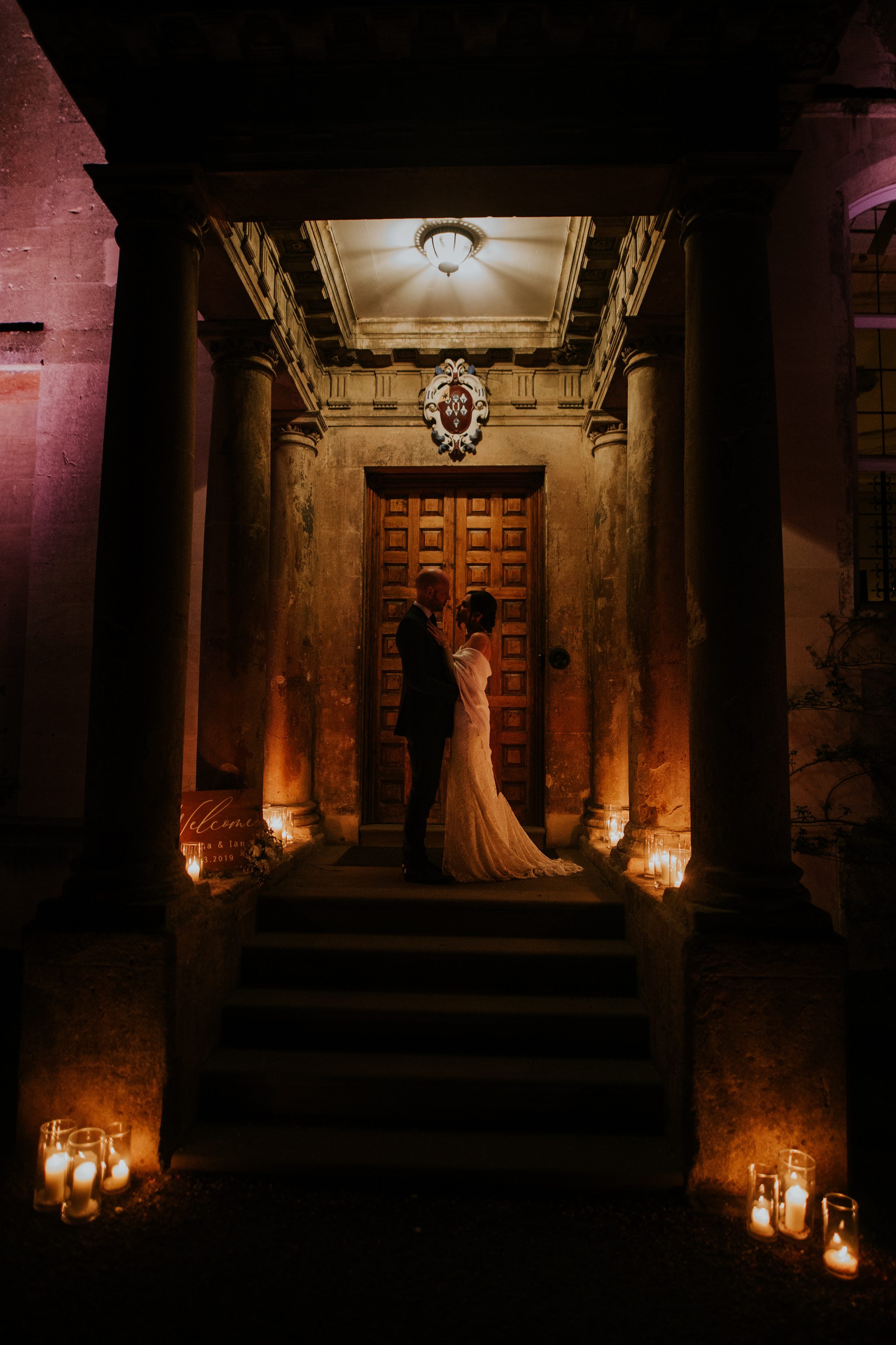 Bride and groom on candle lit steps at Elmore Court