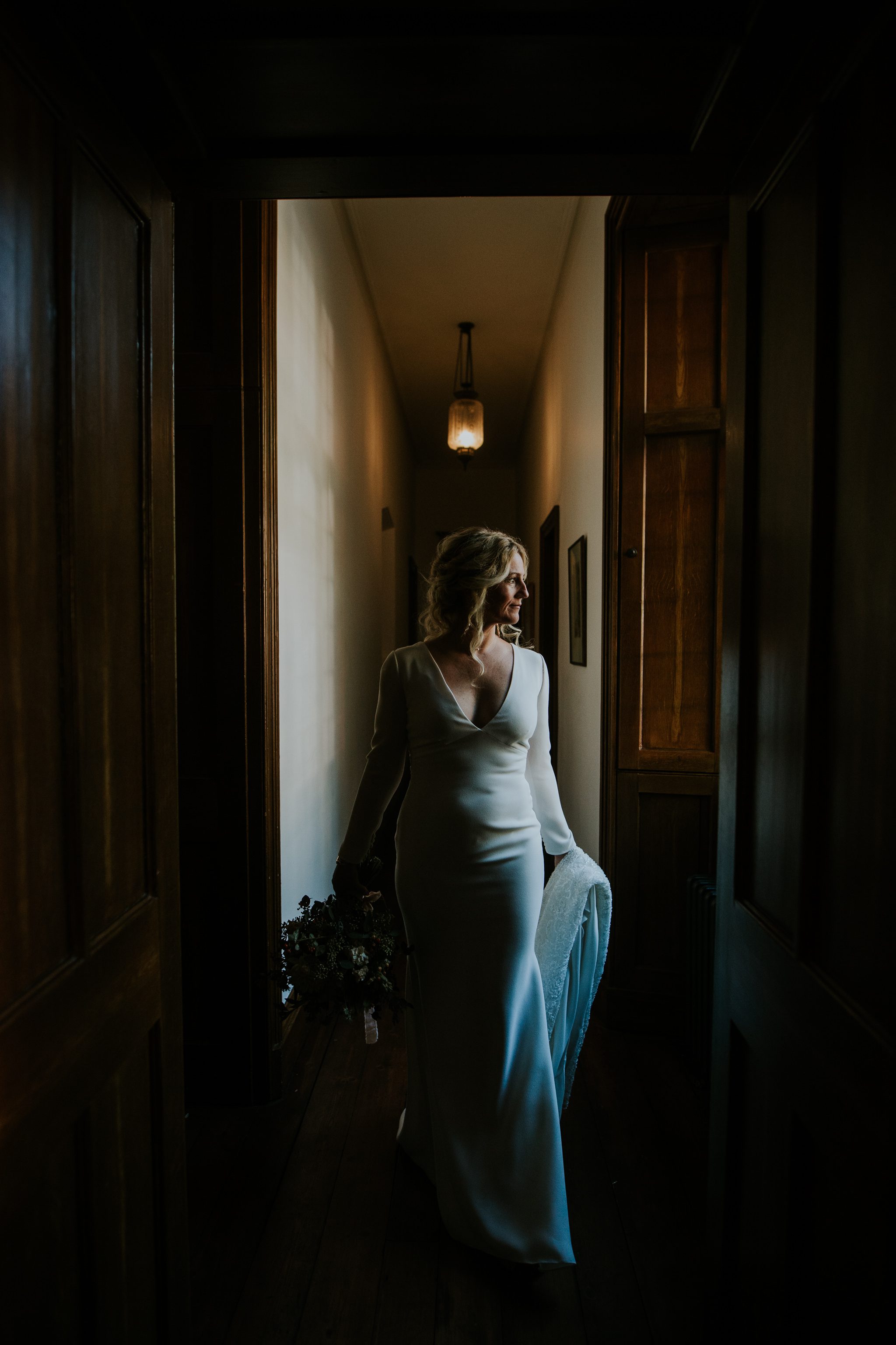A bride walks the corridors at Hotel Endsleigh