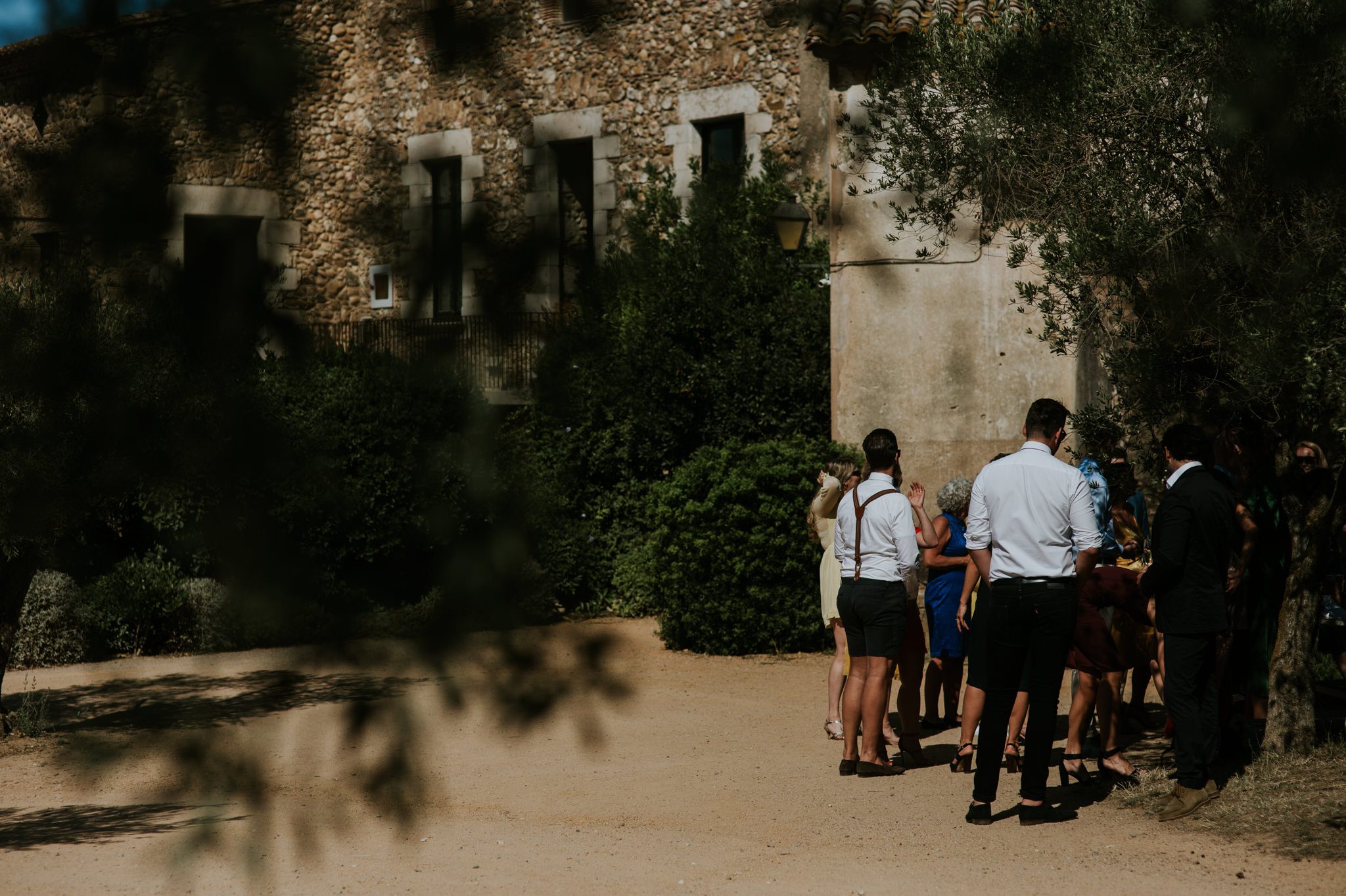 Guests mingle before a wedding ceremony at Castel D'Emporda, Spain