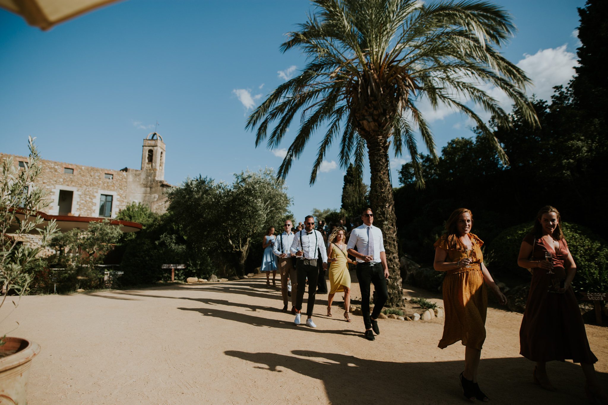 Happy guests arrive for a wedding ceremony at Castel D'Emporda, Spain