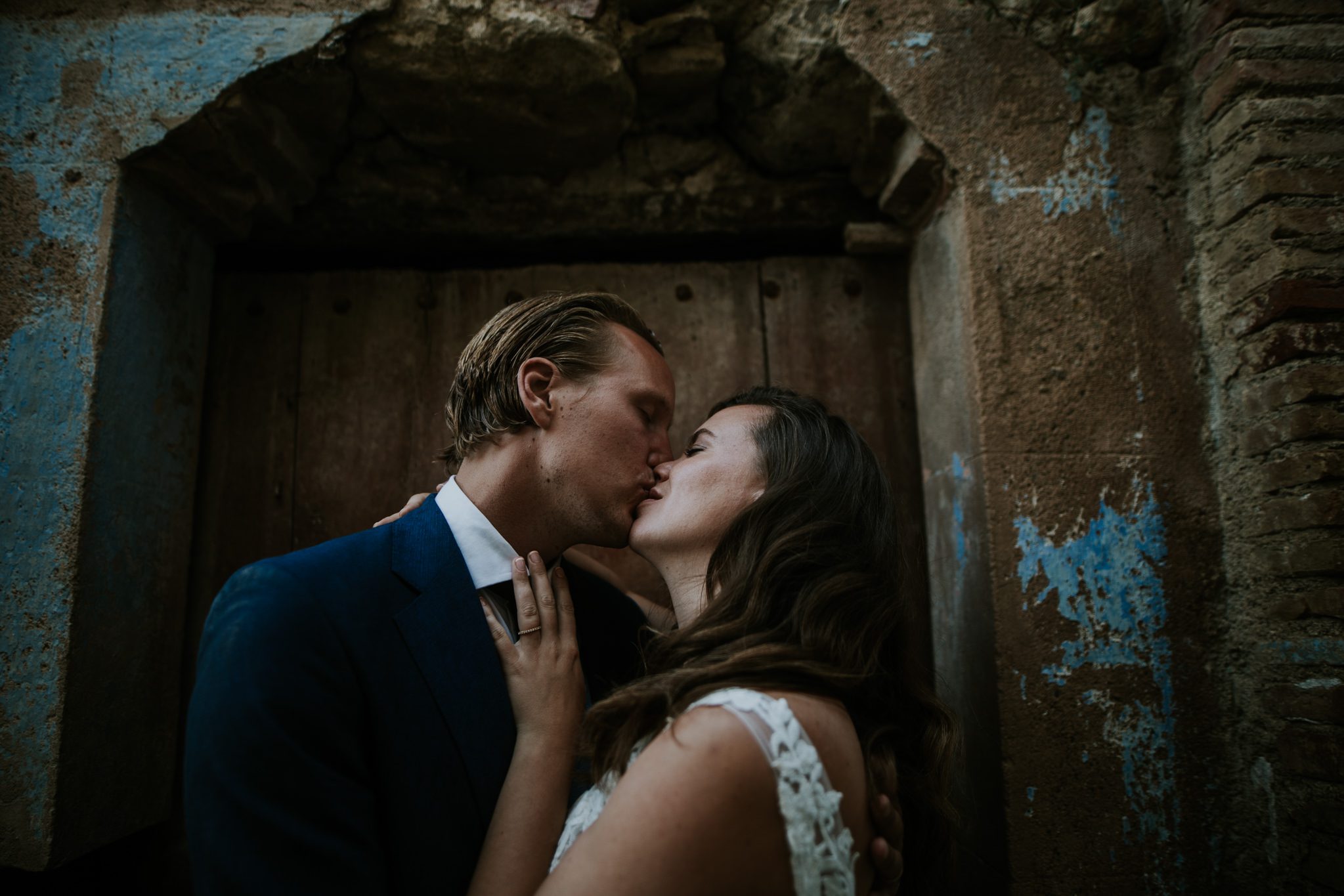 A bride and groom kiss after wedding at Castel D'Emporda, Spain