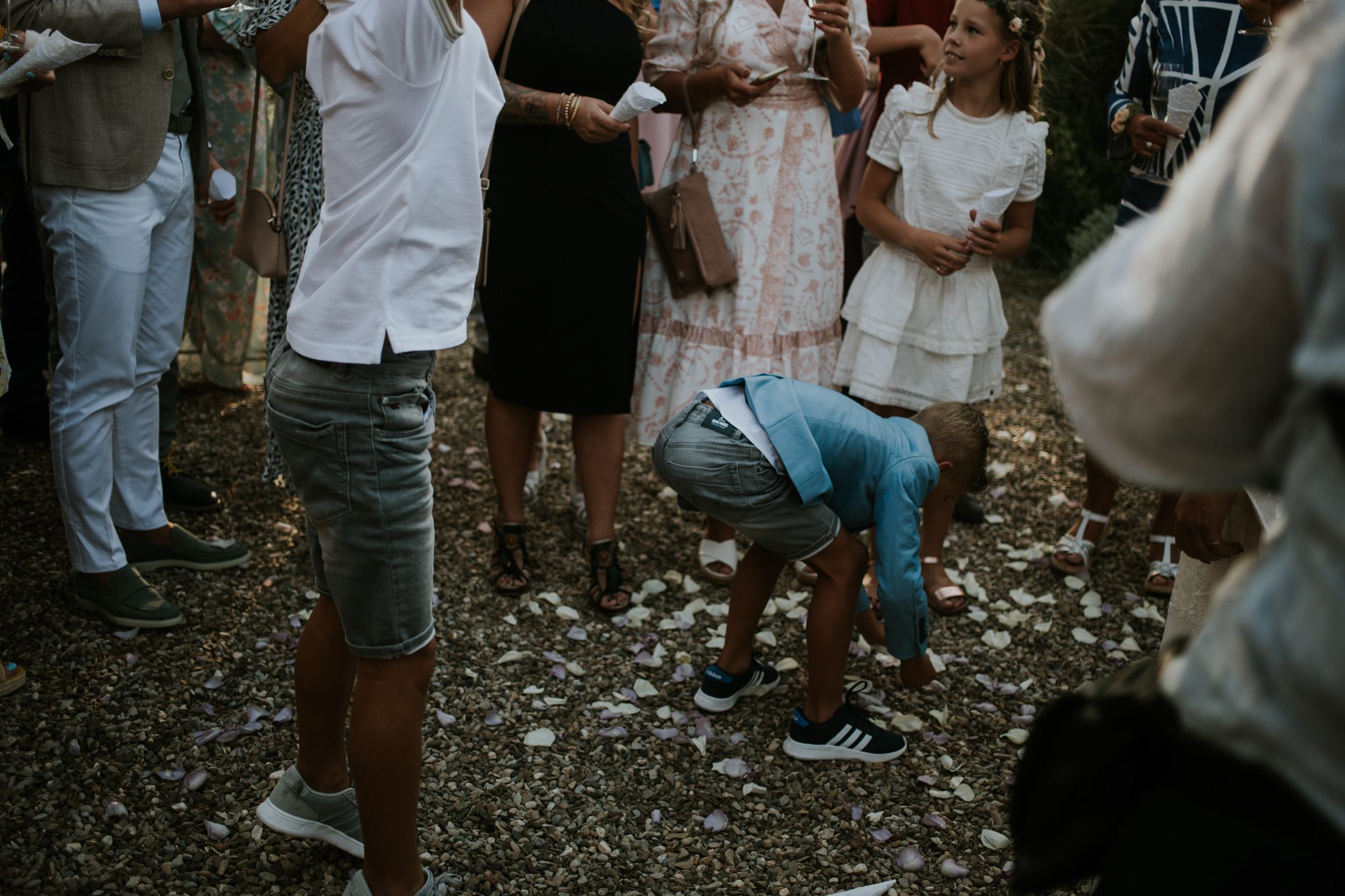 Children play with confetti after a wedding ceremony at Fattoria di Corsigano near Siena in Tuscany, Italy