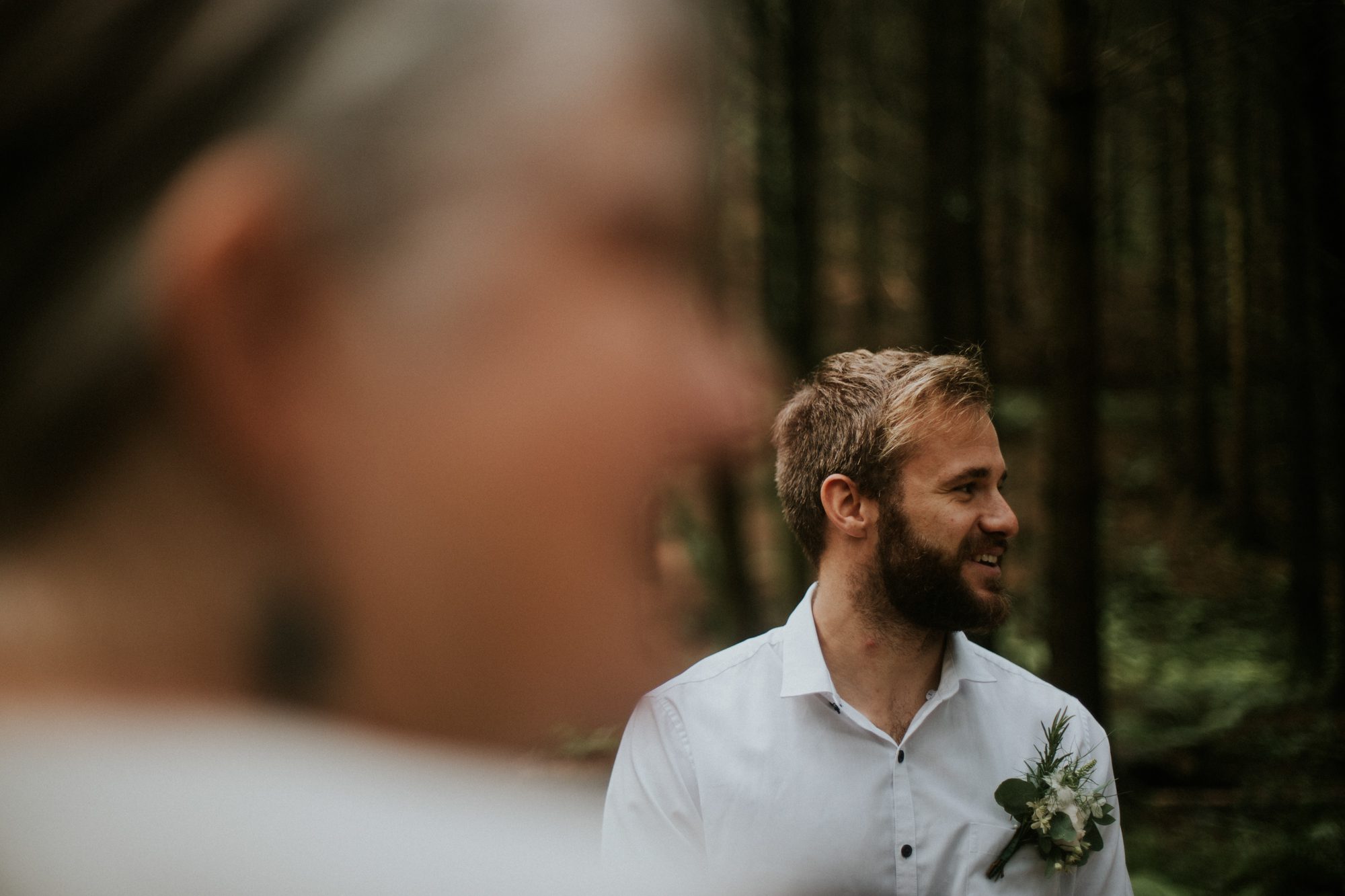 A groom waits for his bride at an elopement at Underpine Woods in Cornwall