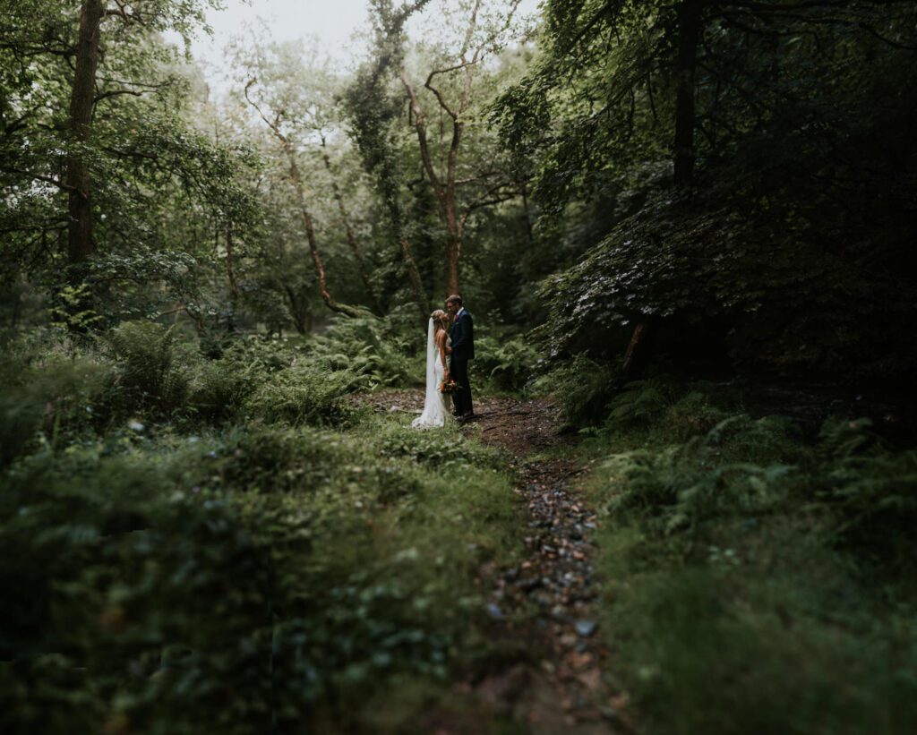 Bride and groom in the woods next to Ever After on Dartmoor