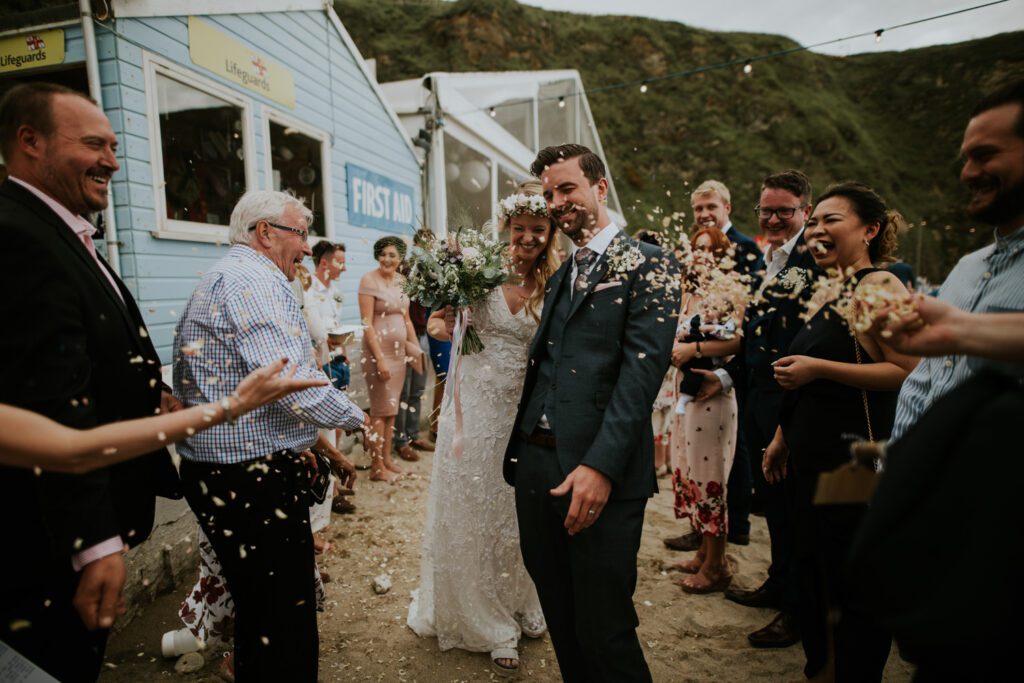 Confetti on the beach at Lusty Glaze wedding venue in Cornwall