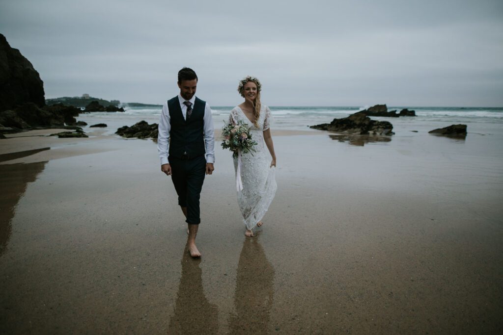 Bride and groom on the beach at Lusty Glaze in Newquay