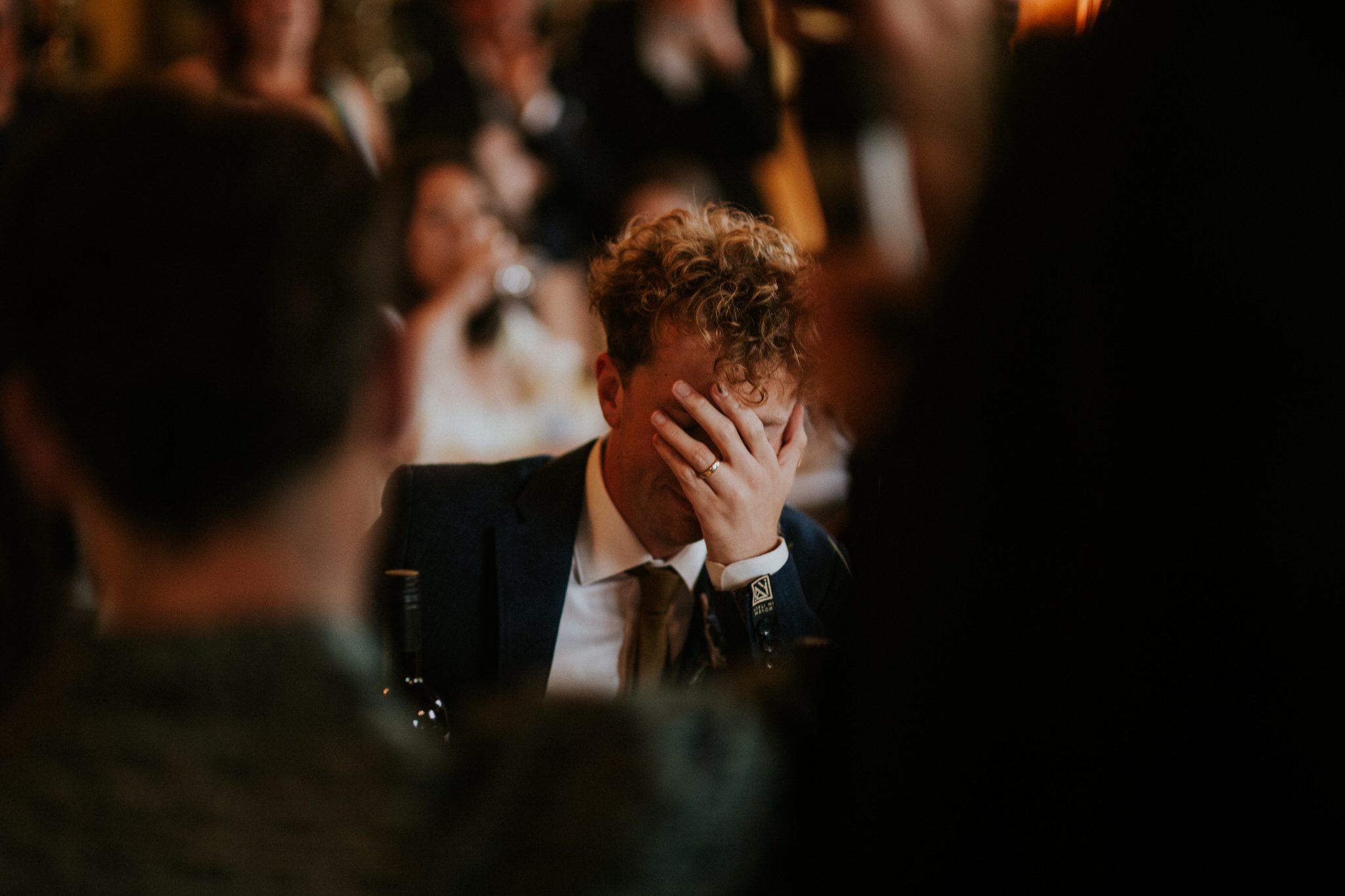 A groom reacts to speeches at a wedding at Huntsham Court in Devon