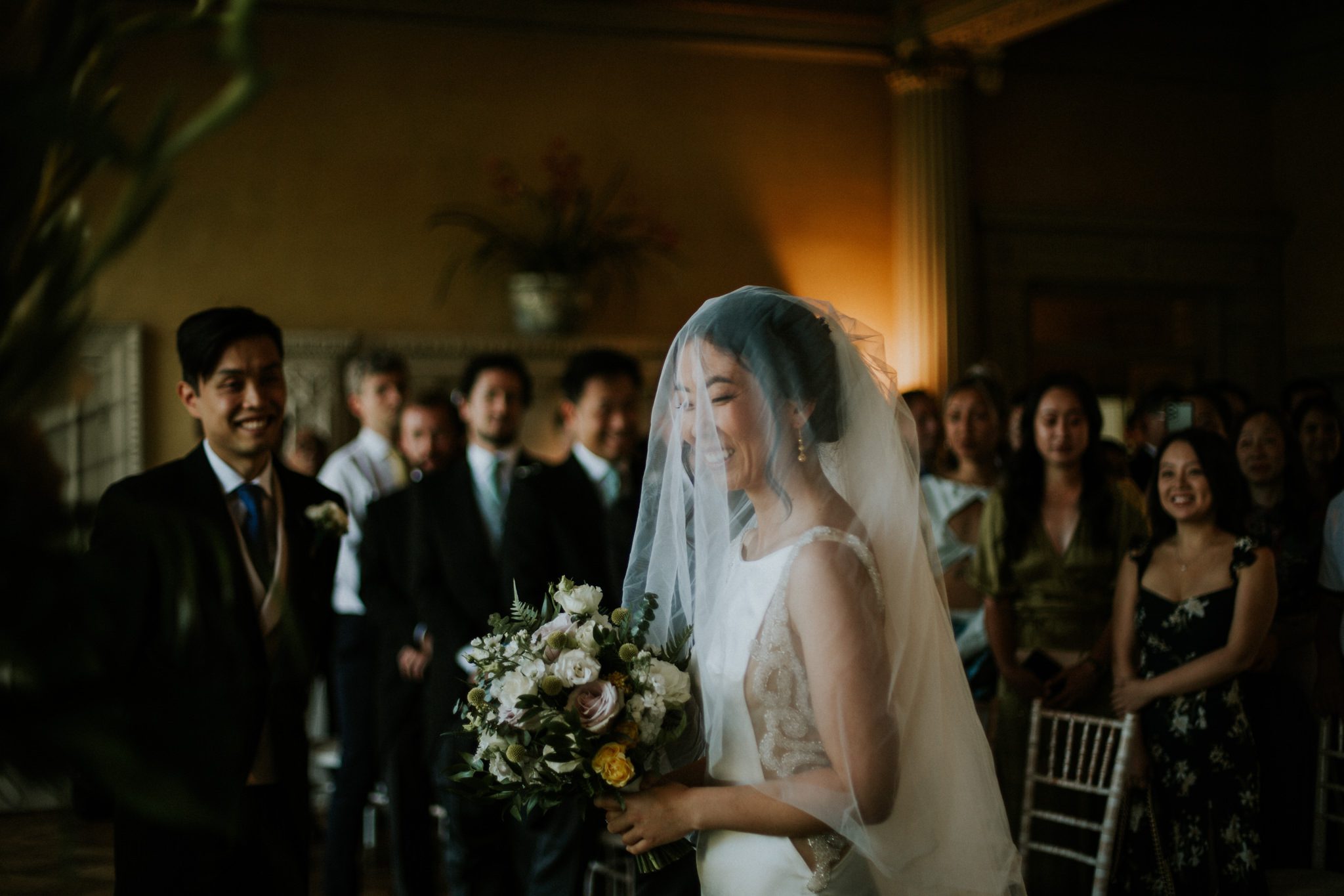 The bride enters the ceremony space at Hampton Court House in London