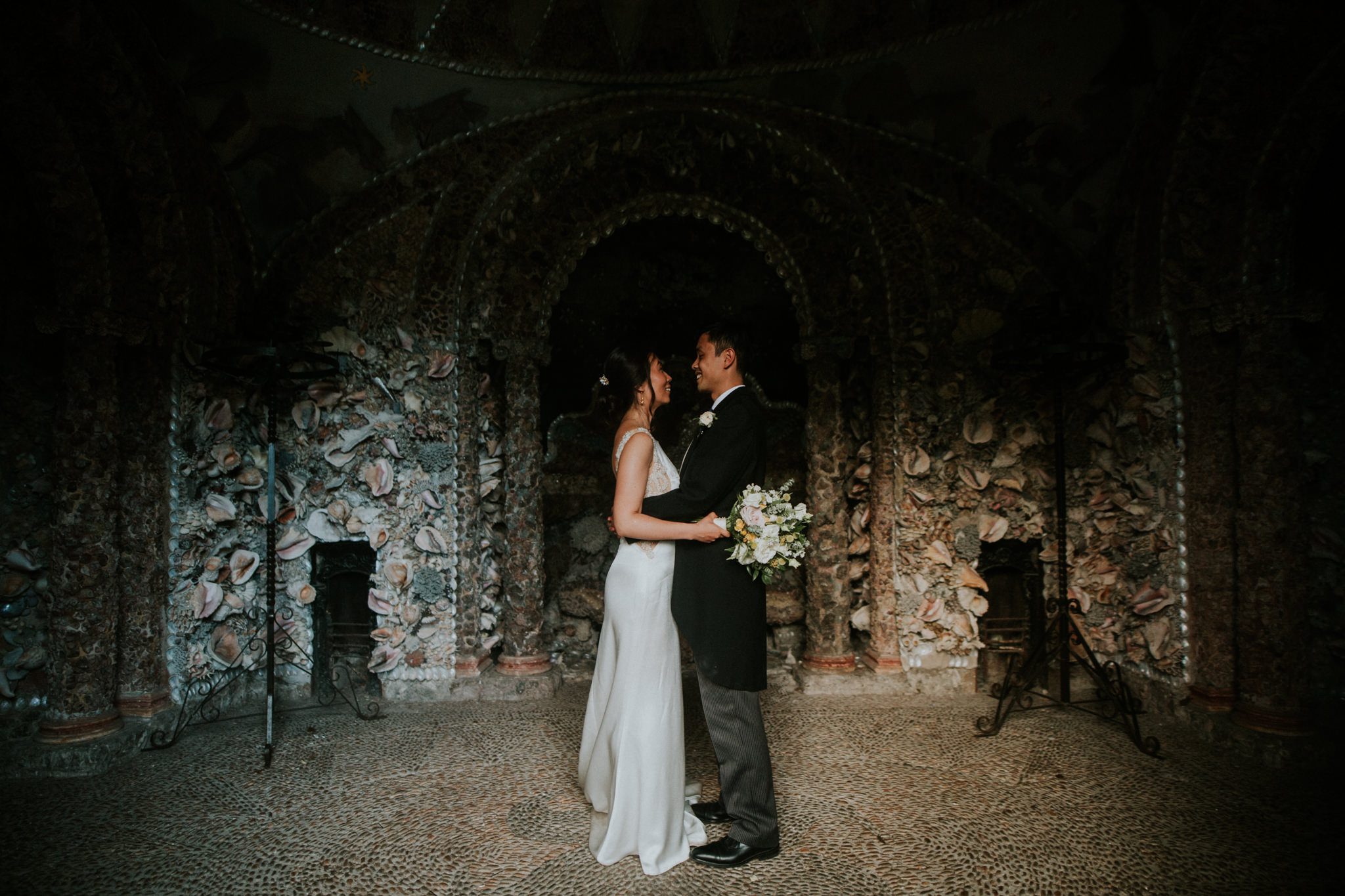 The bride and groom in the magnificent shell grotto at Hampton Court House in London