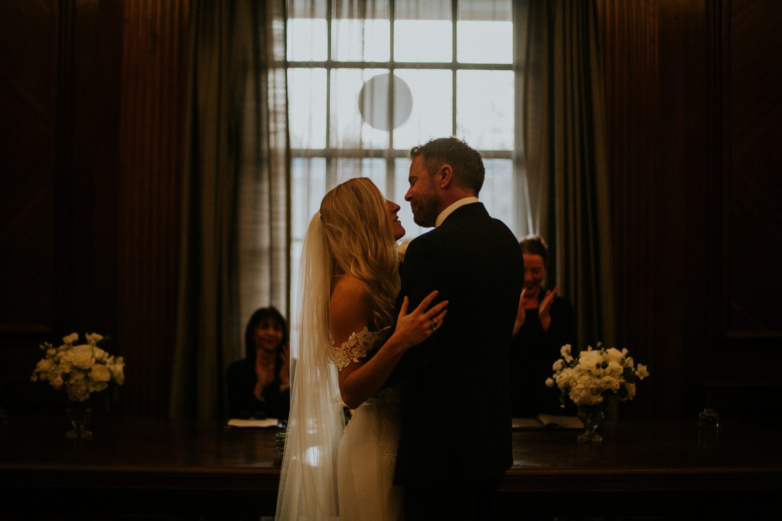 A bride and groom share their first kiss as man and wife during their wedding ceremony at Old Marylebone Town Hall. Old Marylebone Town Hall wedding photography
