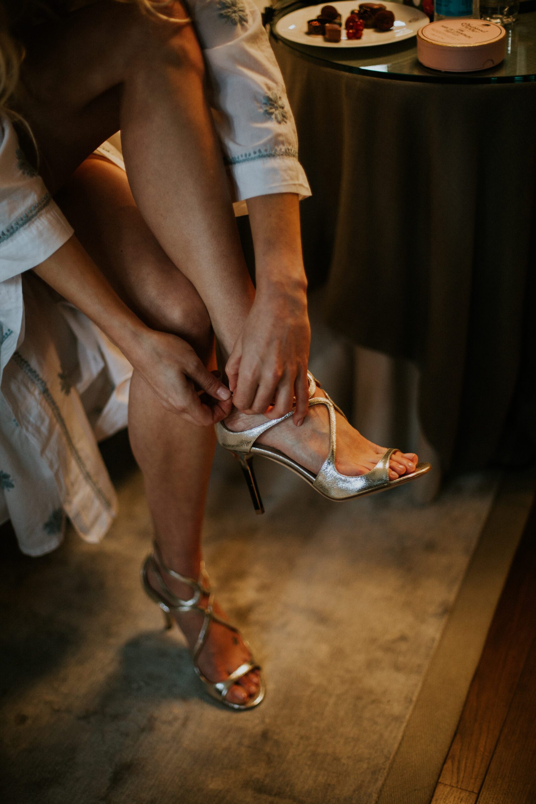 A bride puts on her Jimmy Choo shoes as she prepares for her wedding at The Franklin Hotel, London