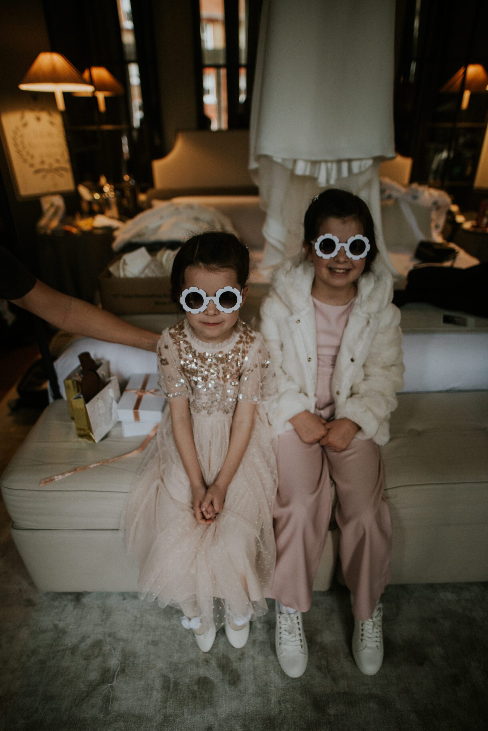 Bridesmaids have fun wearing silly glasses while the bride gets ready for her wedding at The Franklin Hotel