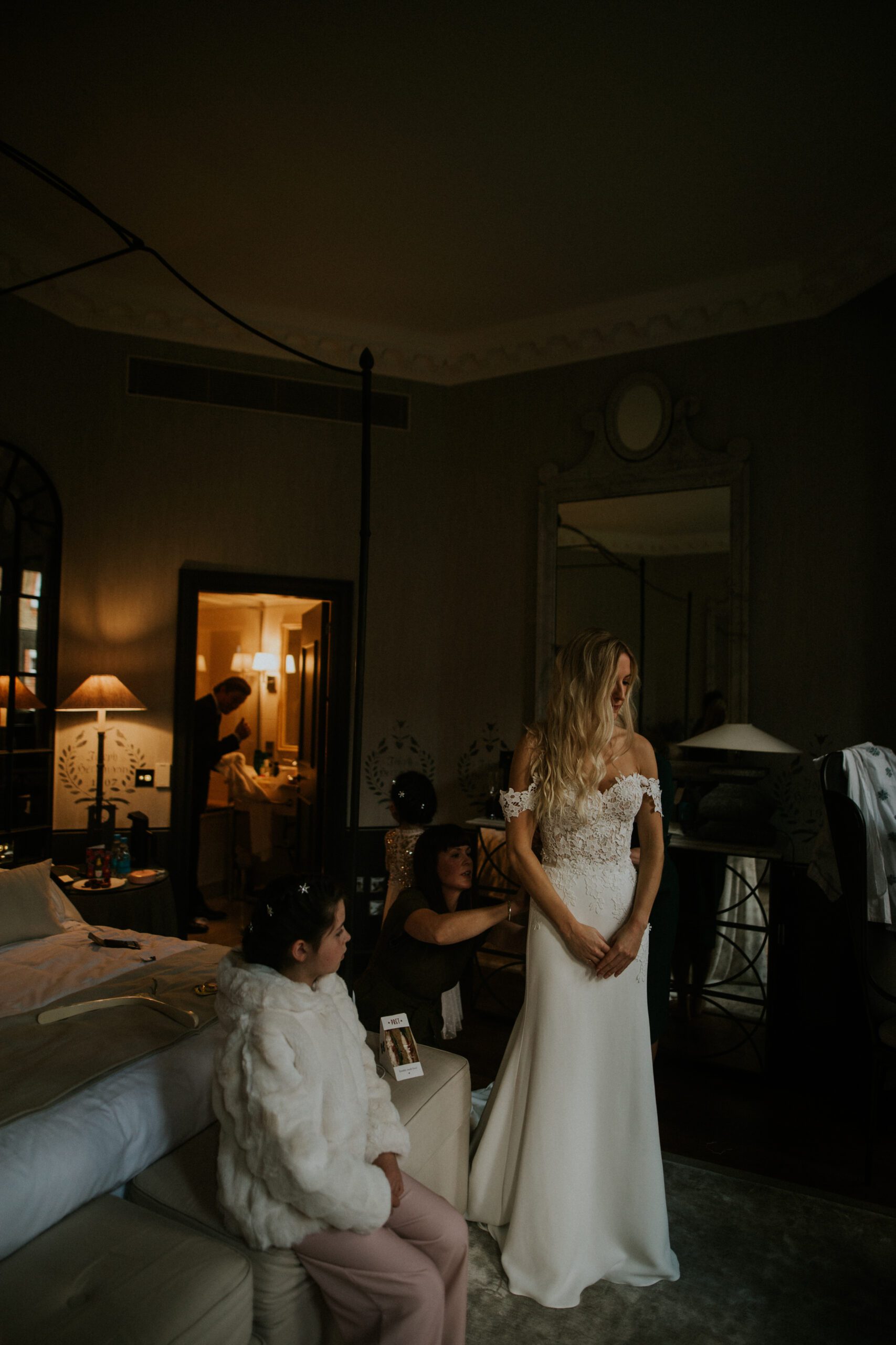A bride looks to a window during the morning of her wedding while she prepares at The Franklin Hotel