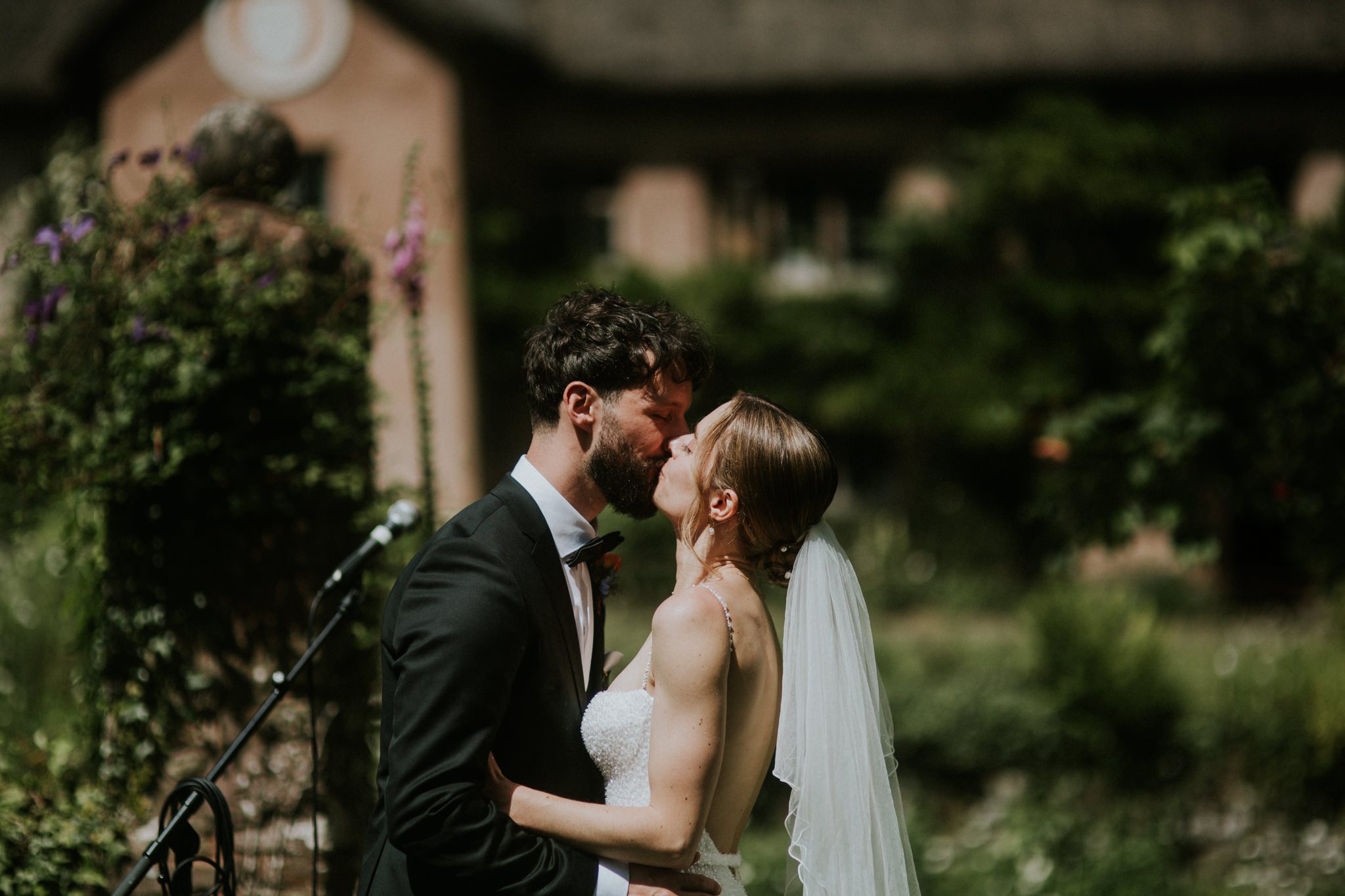 A bride and groom kiss at a wedding at Hayne Devon