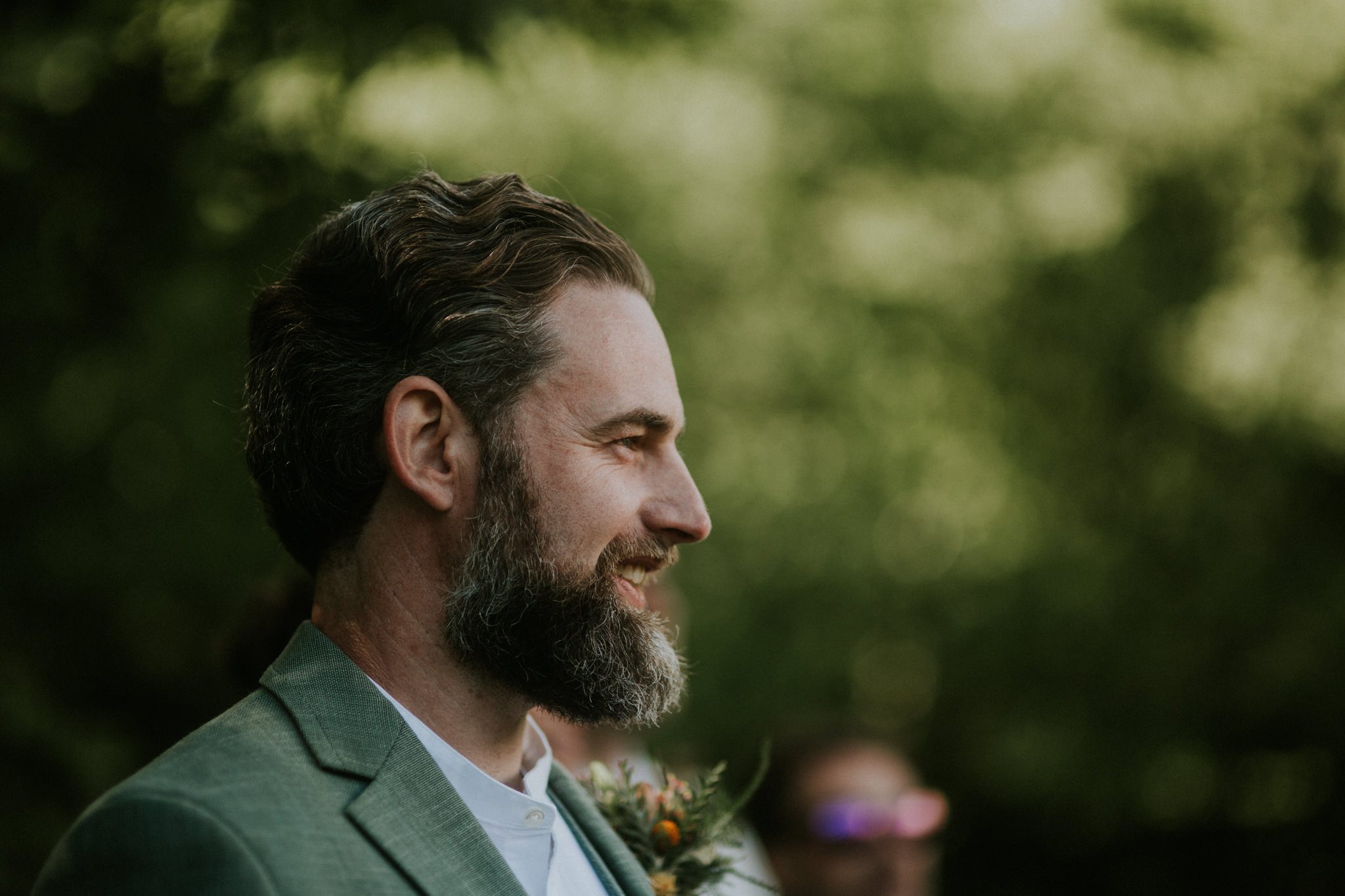 A smiling groom awaits the arrival of his bride at his Wid Wedding at Lower House Farm in Herefordshire