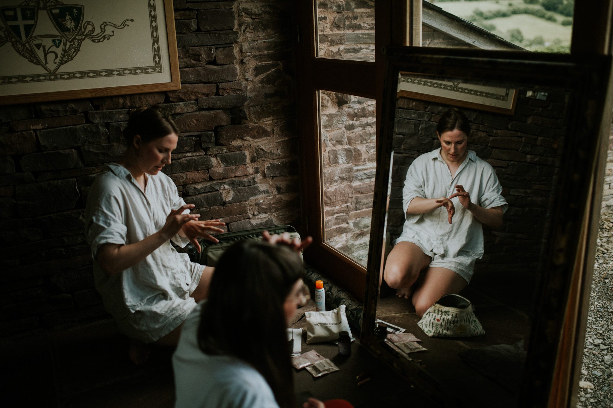 A bride quietly readies herself in the morning before her Wild Wedding at Lower House Farm in Herefordshire