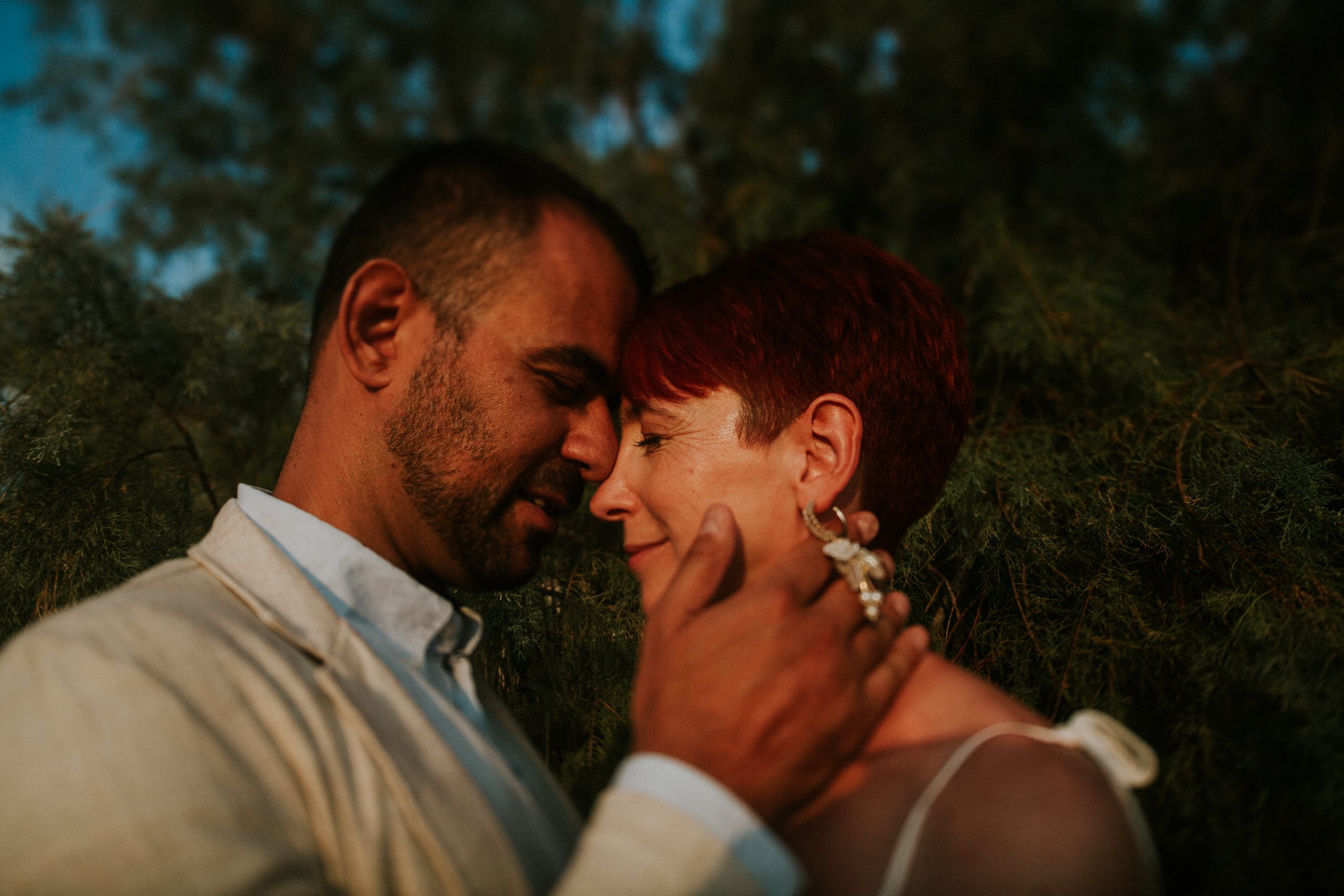 A bride and groom share a quiet moment at their wedding on the Athenian Coast in Greece