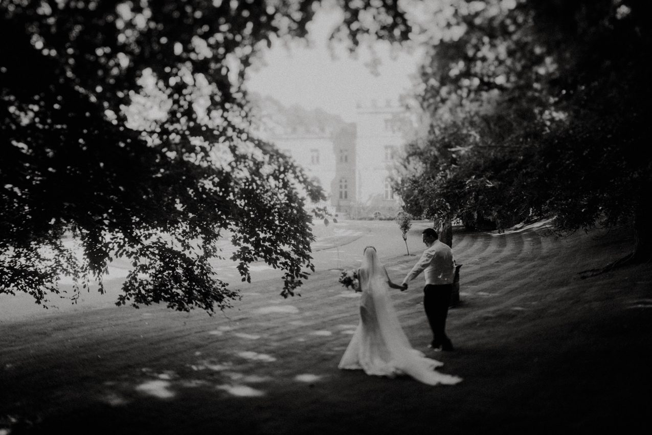 A newly married couple take a walk in the grounds of Clearwell Castle