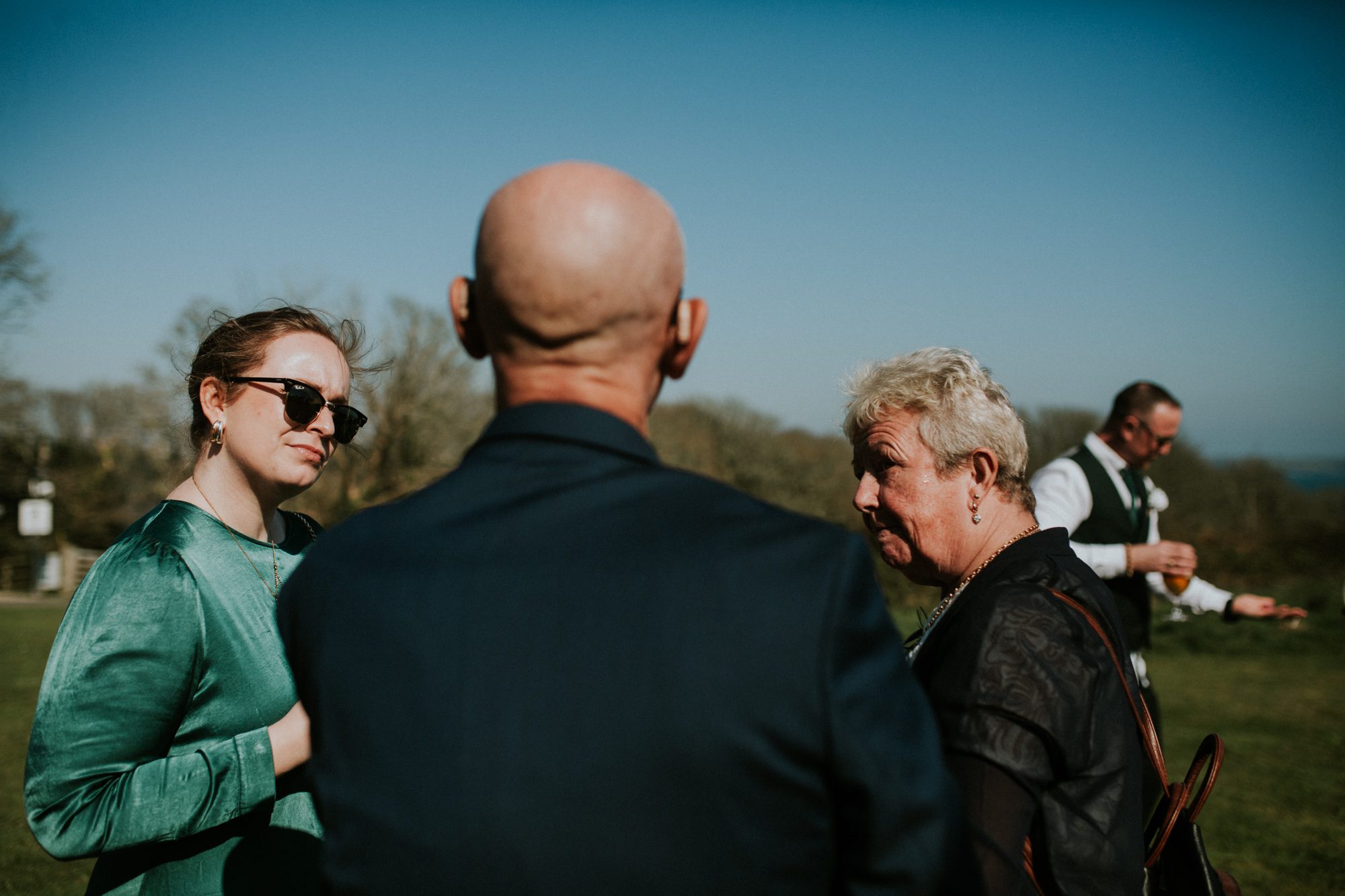 Wedding guests enjoy a quiet chat at a wedding reception at Above the Bay in Falmouth, Cornwall