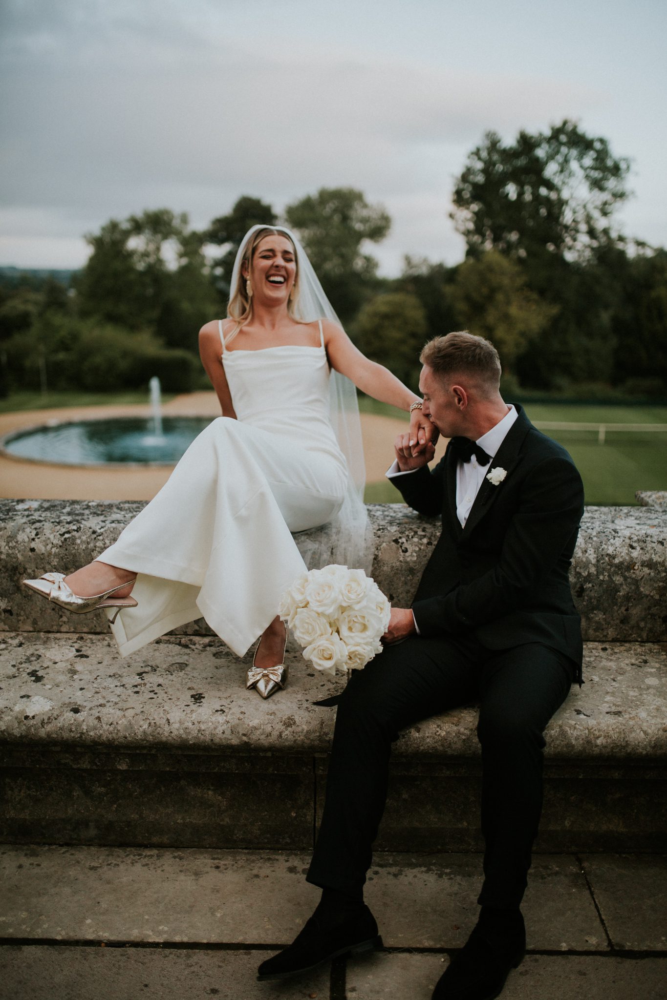 A bride and groom laugh together after their wedding at Bryanston School