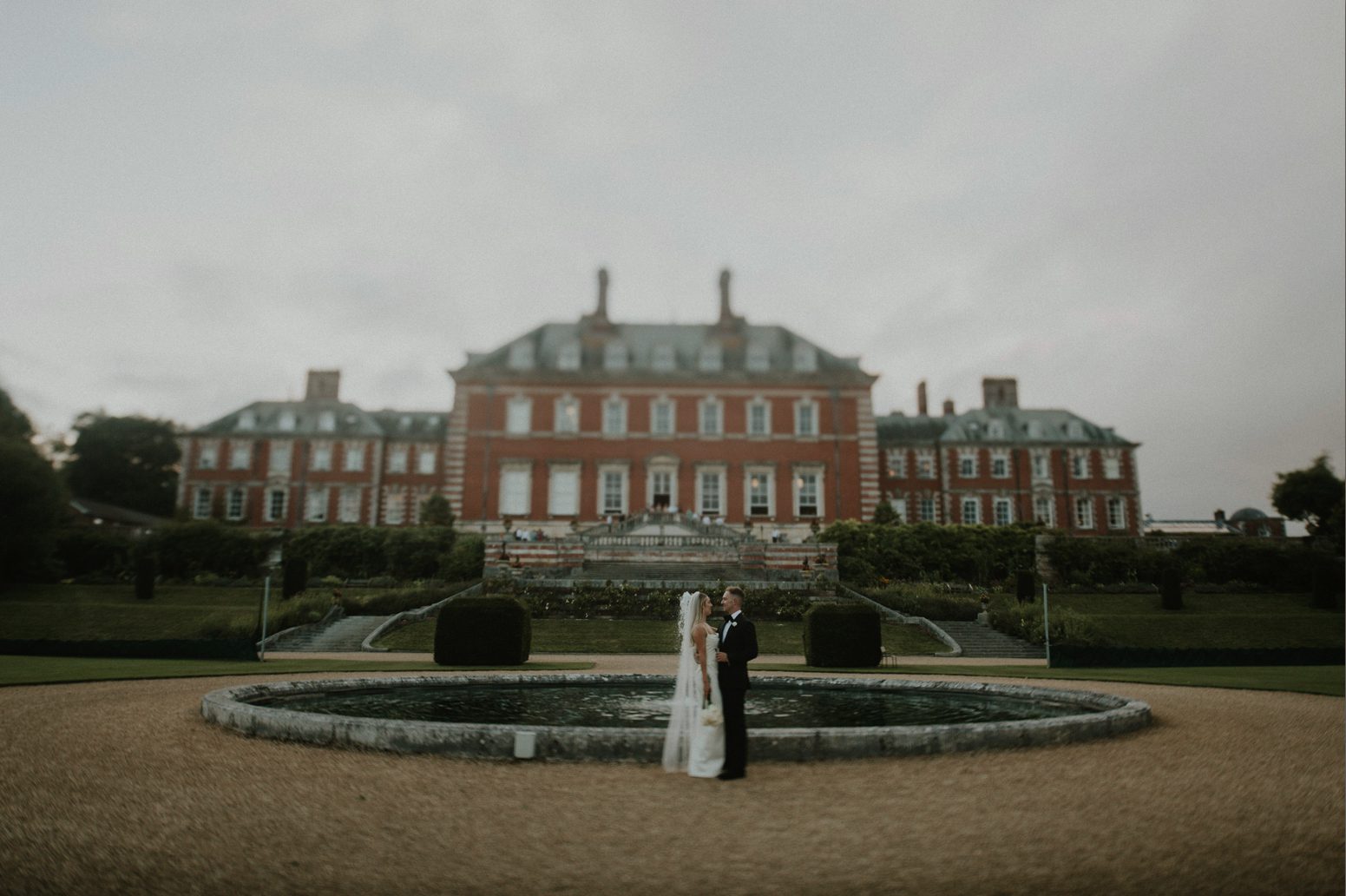 Bride and her groom take a quiet moment in the grounds of Bryanston School