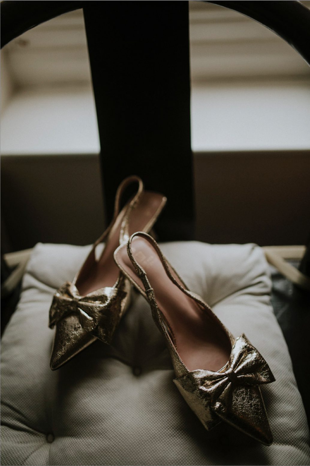 A detail shot of gold wedding shoes
