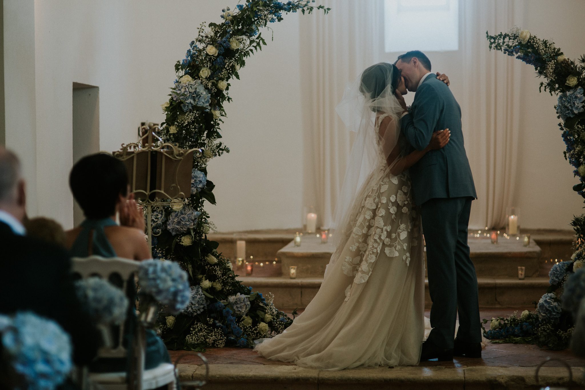 A bride and groom share a first kiss during their wedding ceremony at the wedding venue Chateau St Paul, Marry Me In France