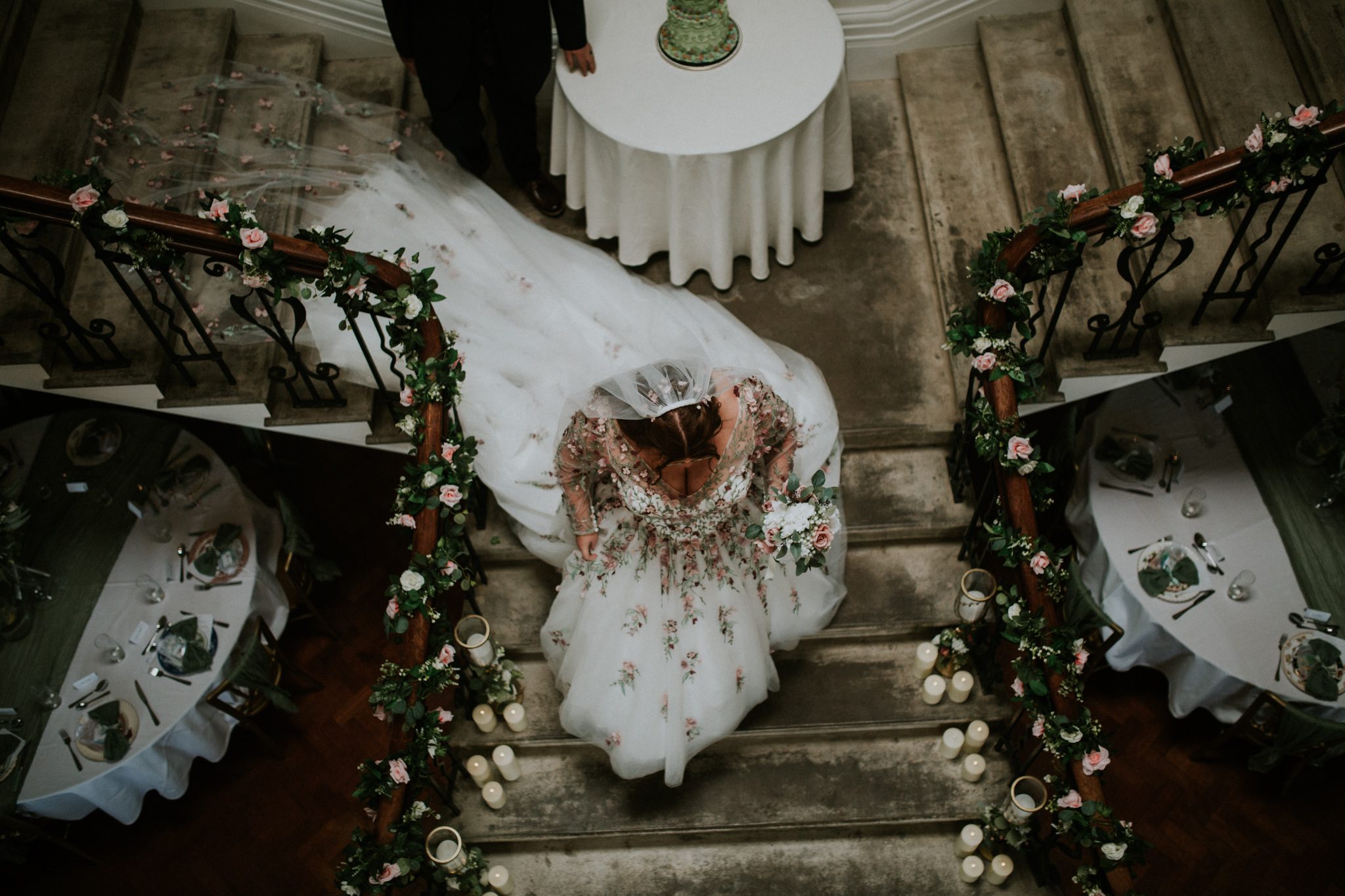 A bride walks down the beautiful staircase at Scorrier House in Cornwall
