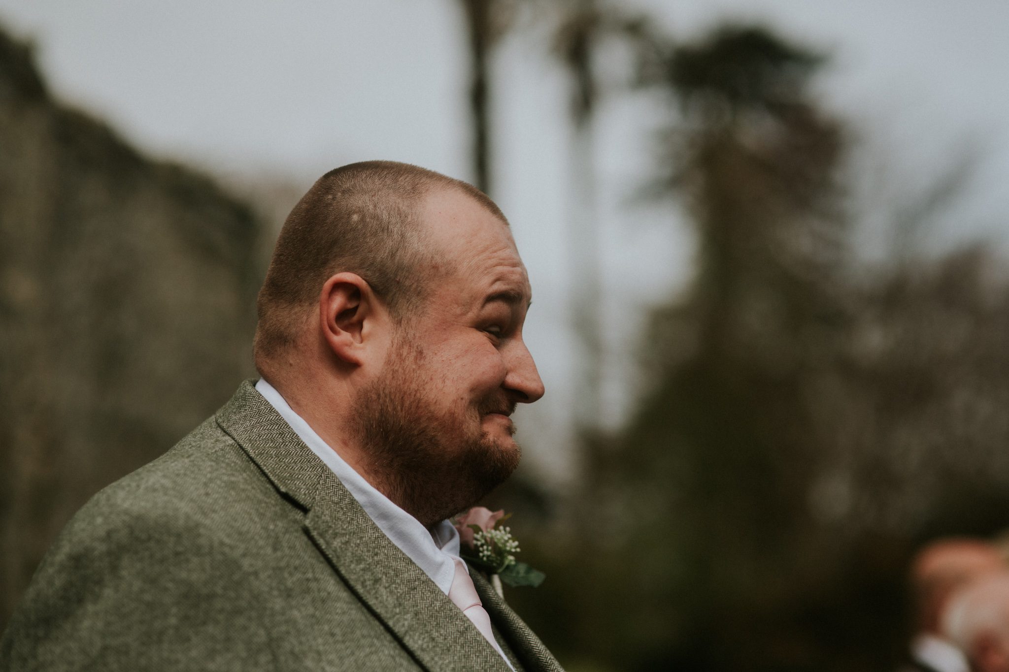 A groom smiles at his wedding at Scorrier House in Cornwall