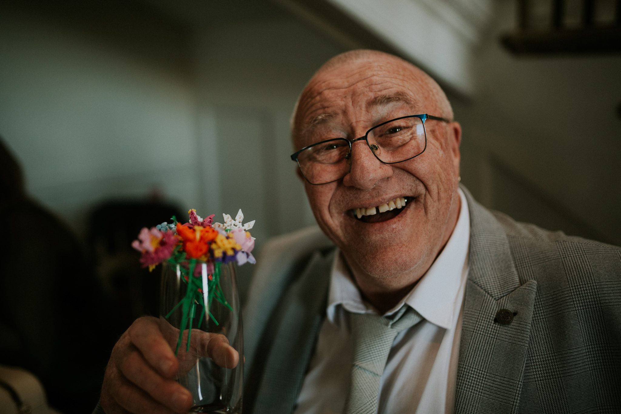 A portrait of a happy wedding guest at Scorrier House in Cornwall