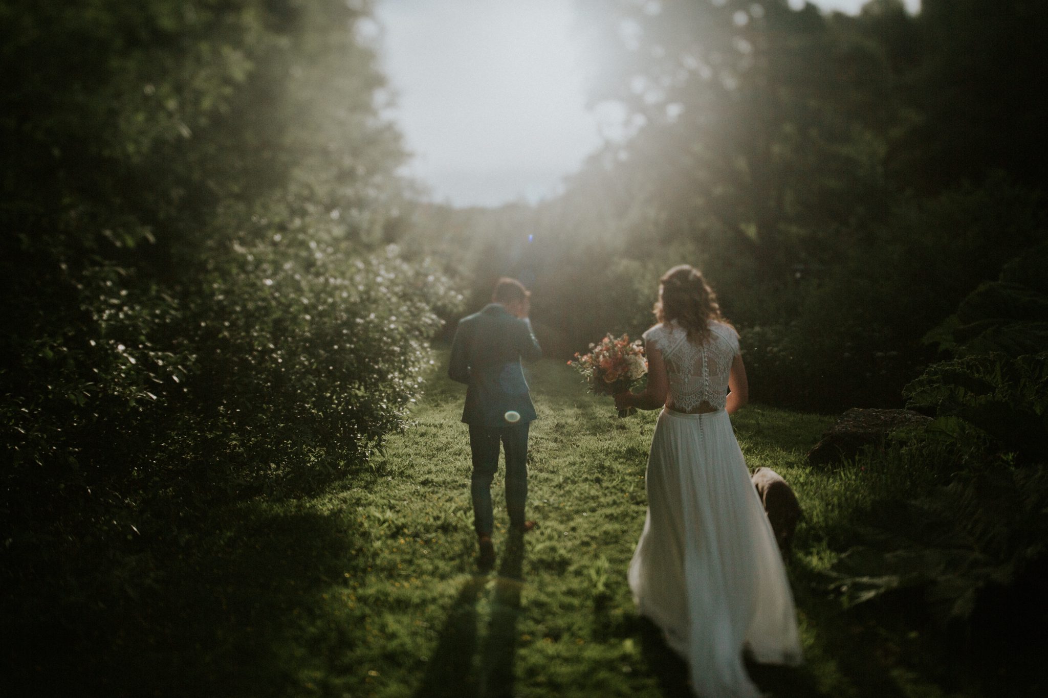 A bride and groom enjoy a quiet stroll in the evening of their wedding at Colehayes Park in Devon