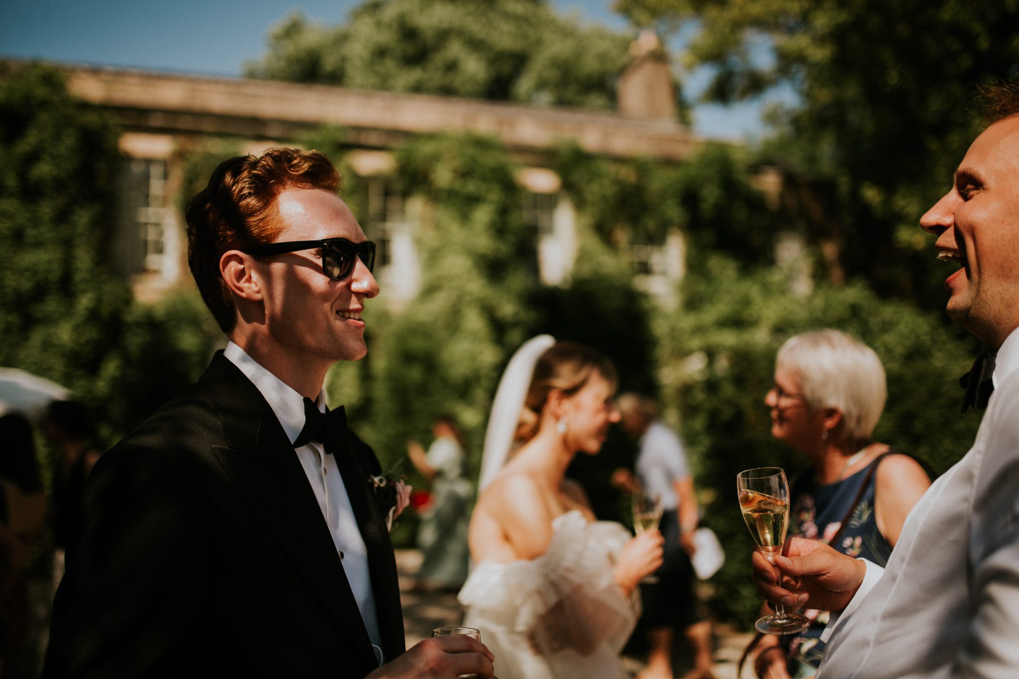 A groom mingles with guests at the reception of his wedding at The Lost Music Hall at Great Ambrook in Devon