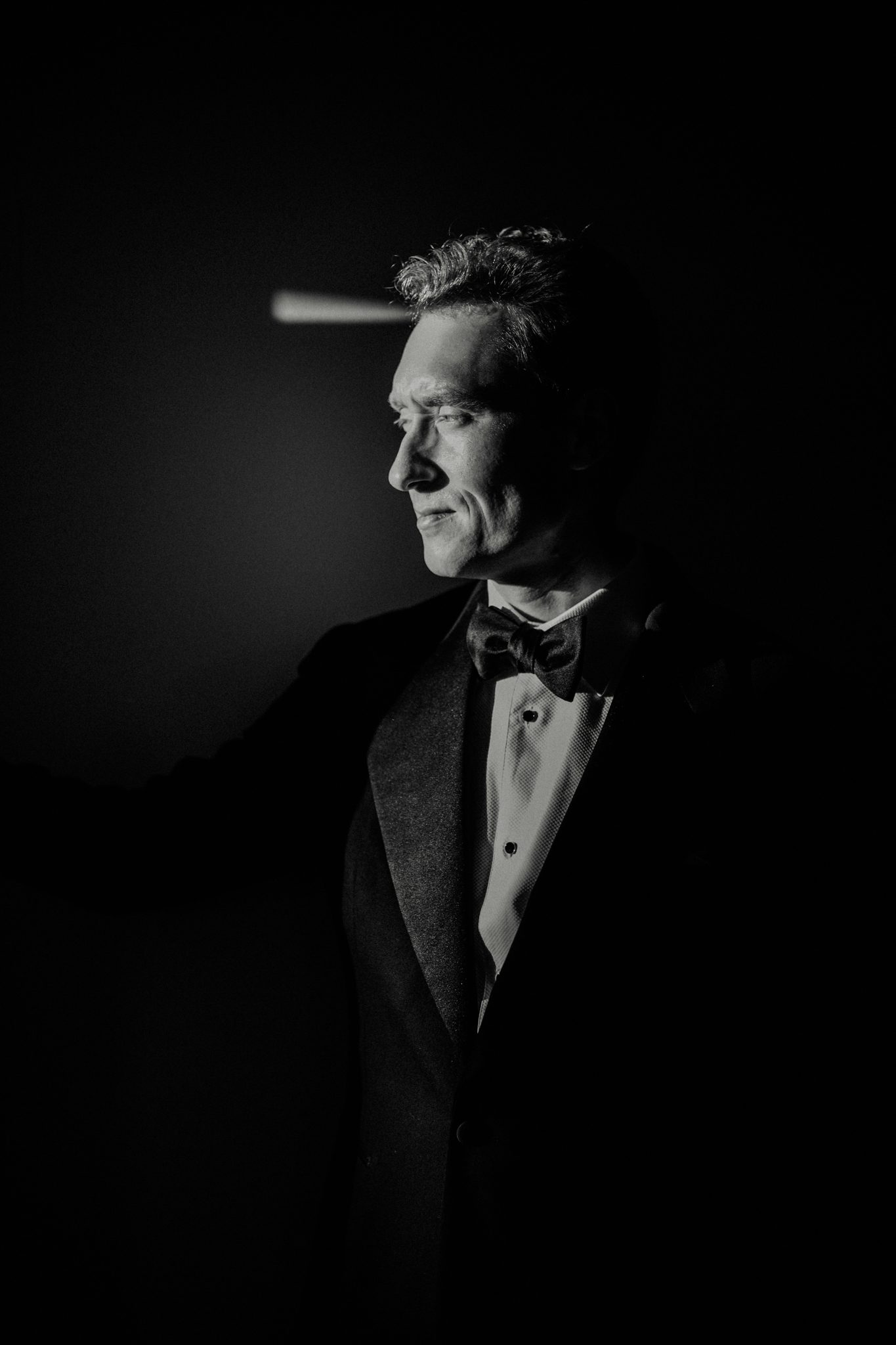 A simple editorial image of a handsome groom after his wedding at The Lost Music Hall at Great Ambrook in Devon