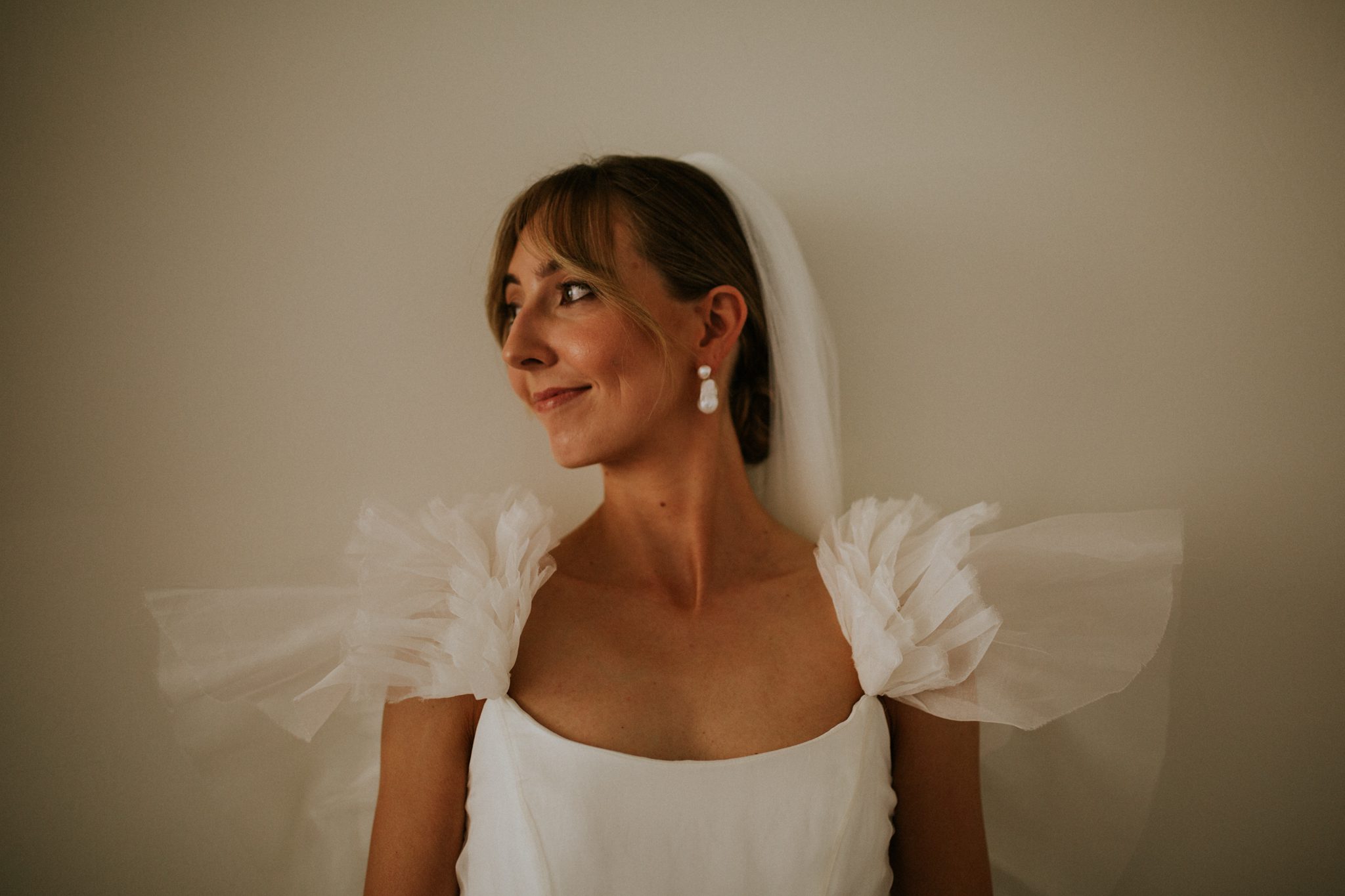 A beautiful bride wearing a Kate Halfpenny before her wedding at The Lost Music Hall at Great Ambrook in Devon