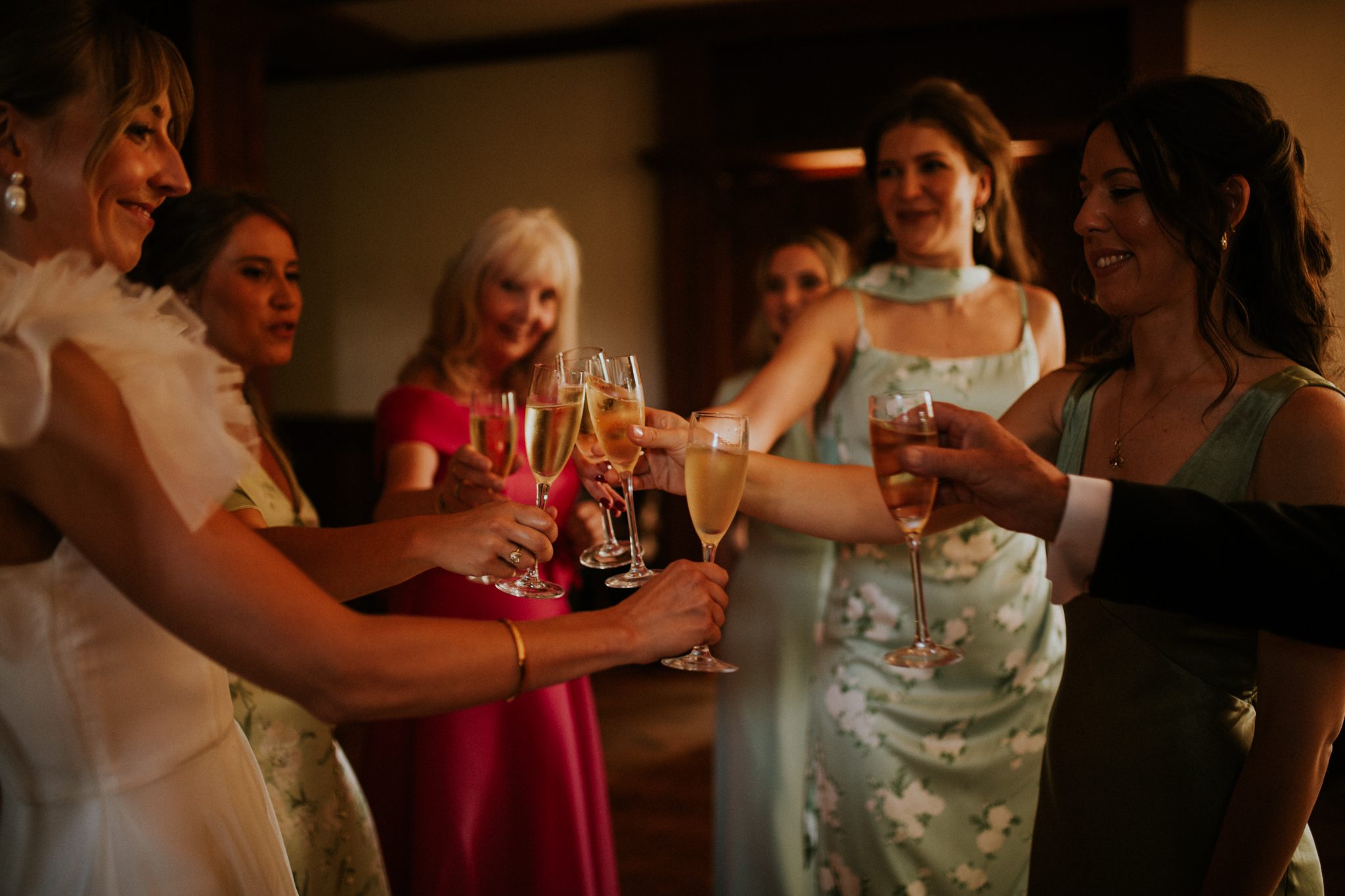 A happy group of women toast a bride before her wedding at The Lost Music Hall at Great Ambrook in Devon